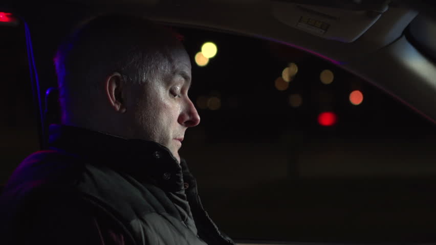 Man being pulled over by police officer with flashing lights