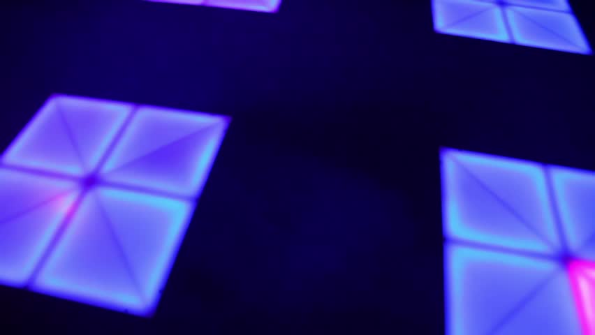 Illumination runs on dance floor with squares, view from above in motion