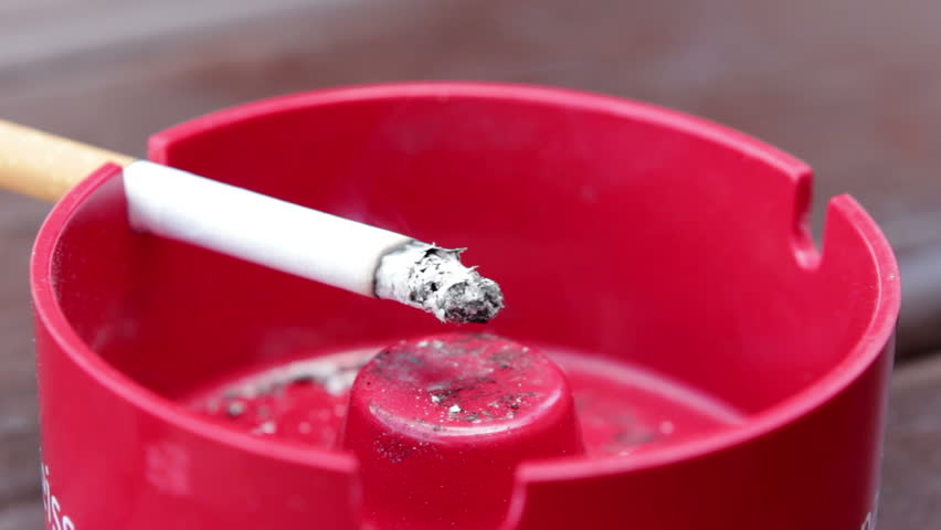 Cigarette in ashtray burning