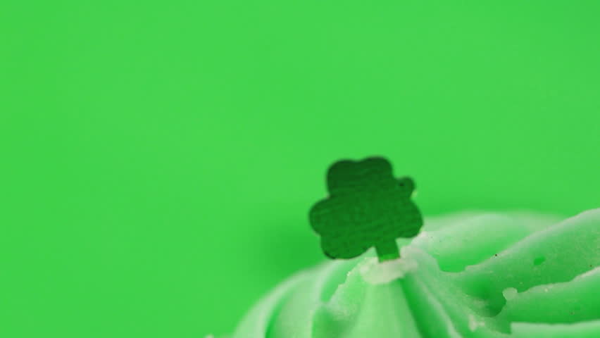 Zoom in on st patricks day cupcake on green background