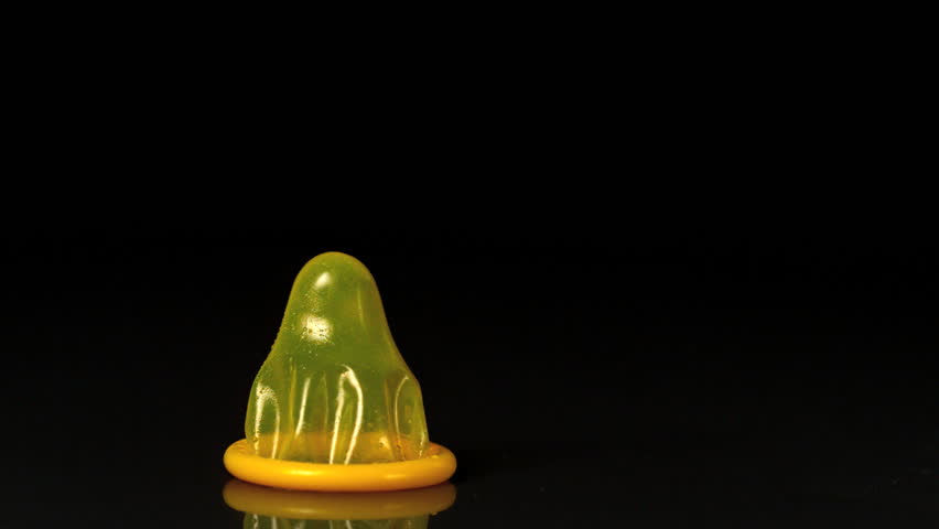 Yellow condom dropping down in slow motion