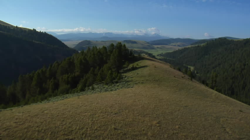 aerial shot of sagebrush pastureland with mountains