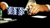 Poker playing placing a bet with chips.