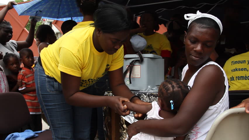 PORT AU PRINCE HAITI  - CIRCA MAY 2012: young Haitian child receives vaccine shot