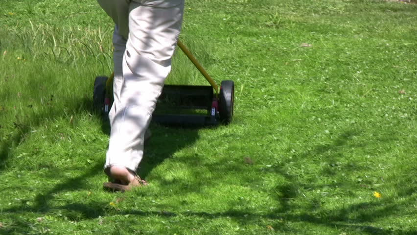Trimming grass with Hand Lawnmower