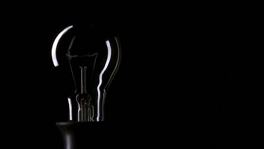 Real light bulb turning on and turning off on black background, copy-space, HD, loopable