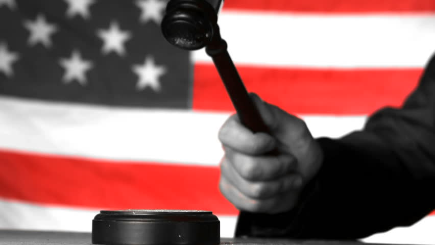 Judge calling order with gavel in american court in selective black and white in slow motion