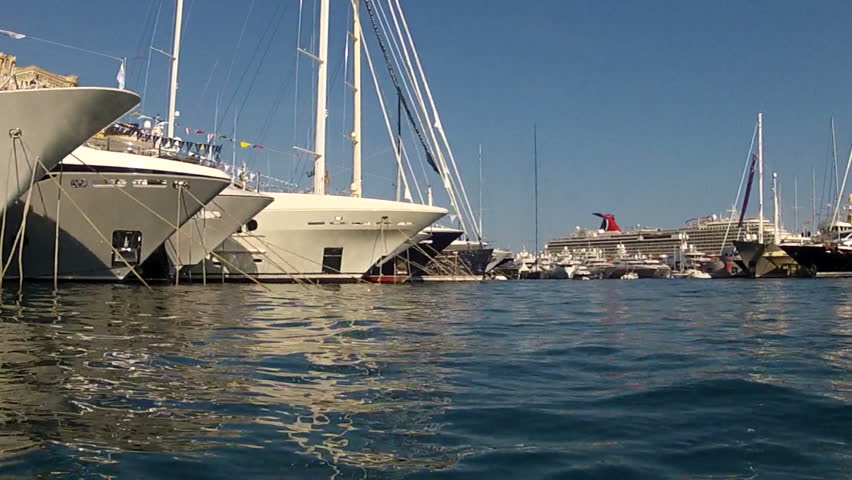 view from surface of water passing infront of large super yachts moored in Port Hercules, Monaco. GoPro HERO2