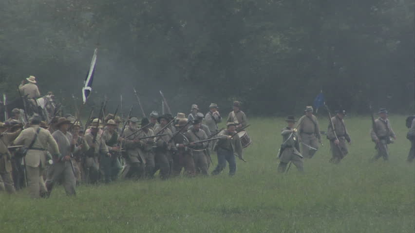 CHICKAMAUGA, GEORGIA - OCTOBER 2008 - large-scale, epic Civil War anniversary reenactment -- in the middle of battle.  Confederate Infantry line of battle advances and fires a volley in combat at Union Army