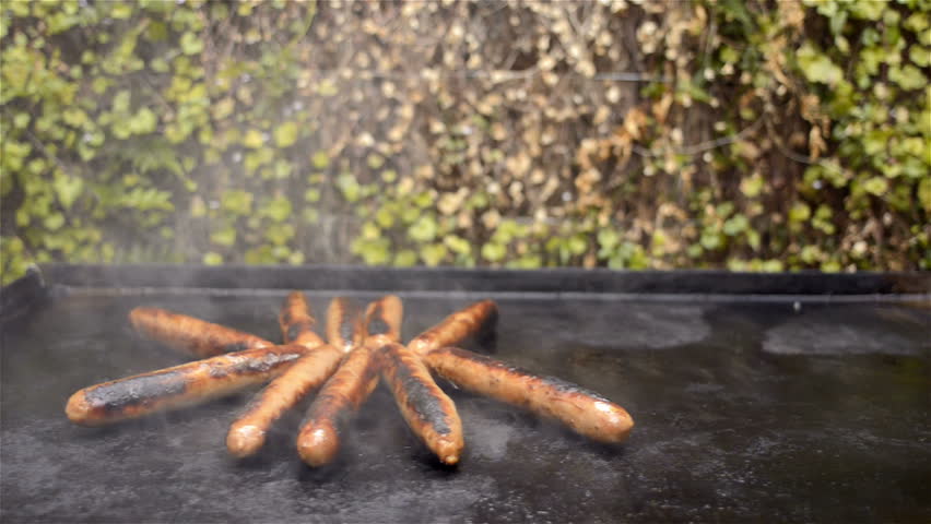Cooking Steaks and Sausages on a Barbecue