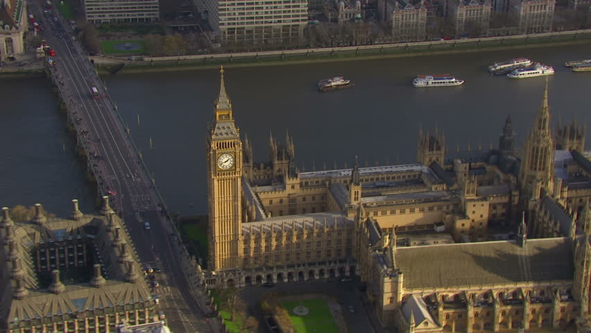 Aerial view flying over the Houses of Parliament and the Westminster bridge in London, England on a bright and sunny autumn day. The bridge joins the city of Westminster and the borough of Lambeth. 