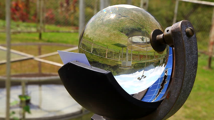Campbell-Stokes Recorder, sun light measuring equipment, with reflection of anemometer
