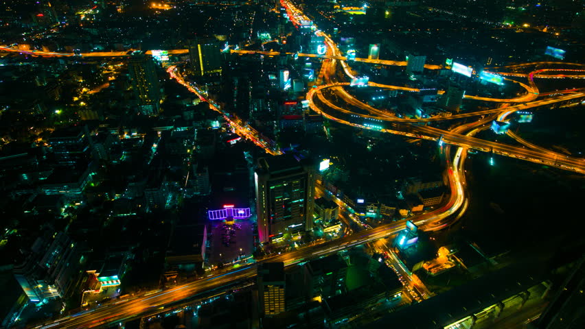 Aerial view of highway and cityscape at night, Time lapse
