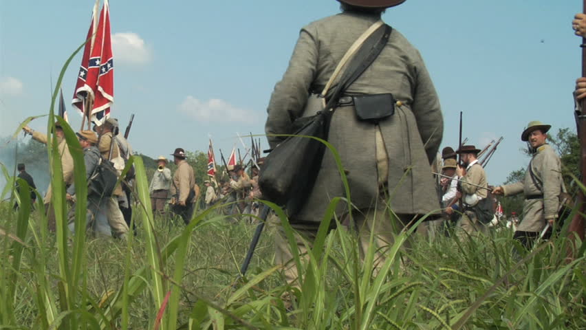 GEORGIA - OCTOBER 2008 - large-scale, epic Civil War anniversary reenactment -- in the middle of battle.  Confederate Soldiers advance under fire into battle.  Long line of advancing infantry.