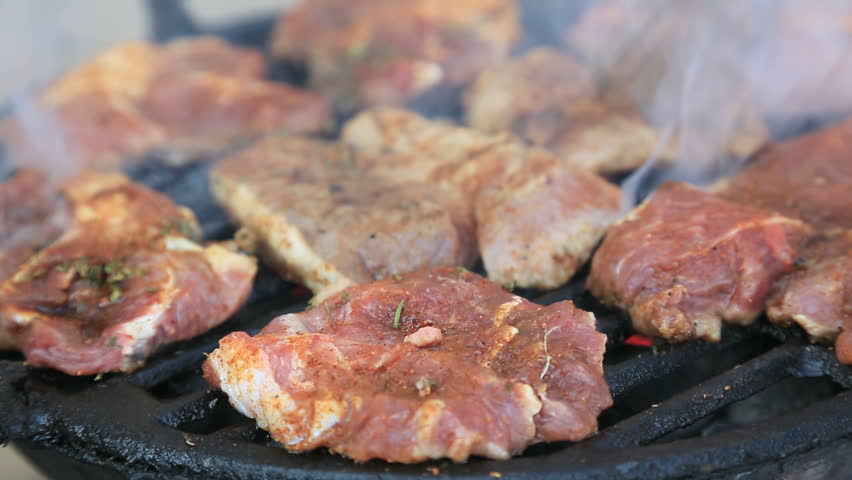 Pork steaks on barbecue grill