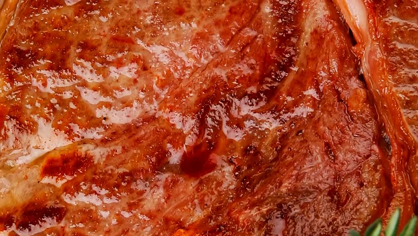 savory : grilled spare rib on white dish with thyme pepper and tomato on wooden table