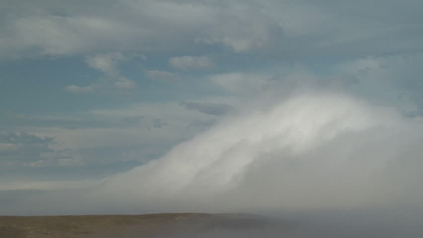 Gravity Waves. Breaking gravity waves on top of valley fog bank break over a hillside
