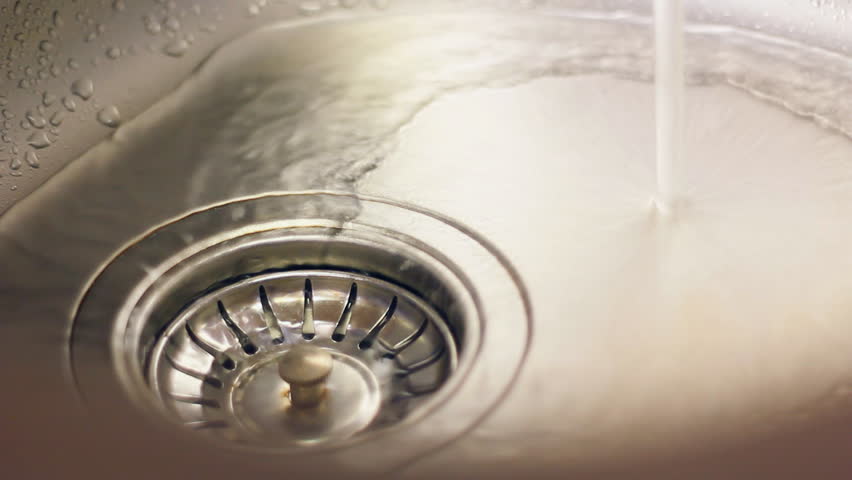 water flows from the tap into the sewer