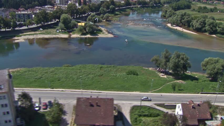 Aerial shot of a very interesting river in residential area with people taking swim