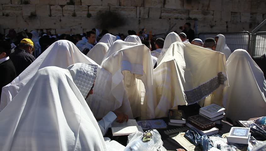 JERUSALEM, ISRAEL -  MARCH 28: Cohanim raise their hands during Priestly Blessing  (Hebrew - Birkat Cohanim) at the Western Wall plaza during the Passover Holiday, March 28 2013 in Jerusalem, Israel.