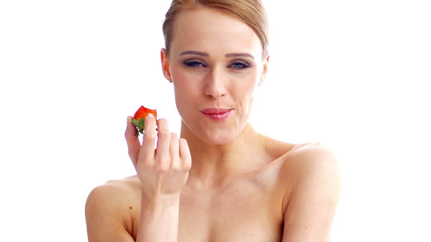 Happy Woman Eating Fresh Strawberry While Isolated on White

