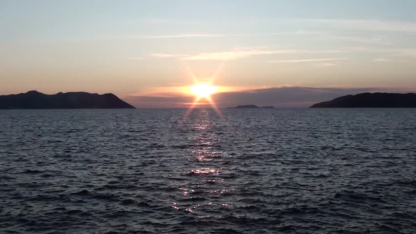 Sunset, sea, ripples waves, clouds, islands, mute