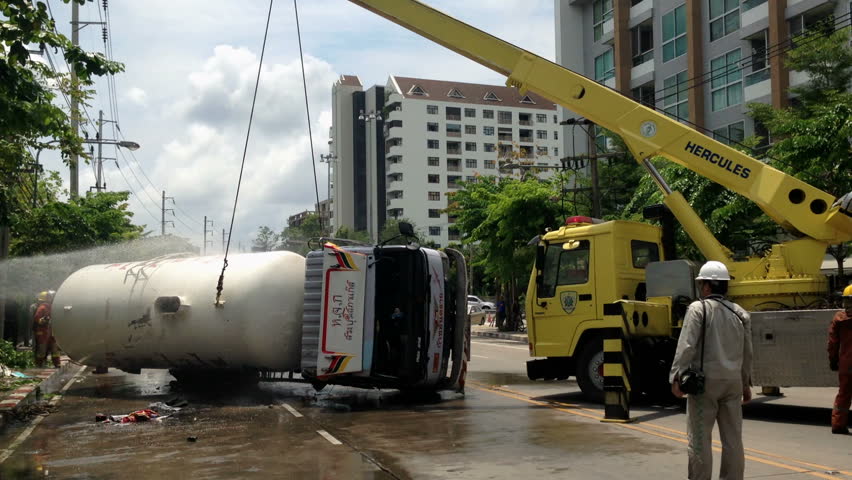 BANGKOK - APRIL 15: A rolled-over gas truck is being craned back on wheel in Bangkok, Thailand, on April 15, 2013. The gas truck crashed after a brake failure