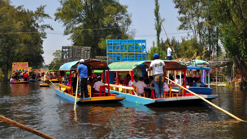 MEXICO CITY - MARCH 24 - (Timelapse View) Traditional colorful boats float down the Xochimilco canal on March 24, 2013.  Xochimilco canal is popular place for both locals and tourists to relax.