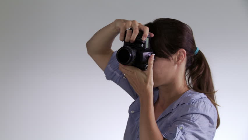 Female photographer working with male model in studio, close up Edgy, hand-held camera.