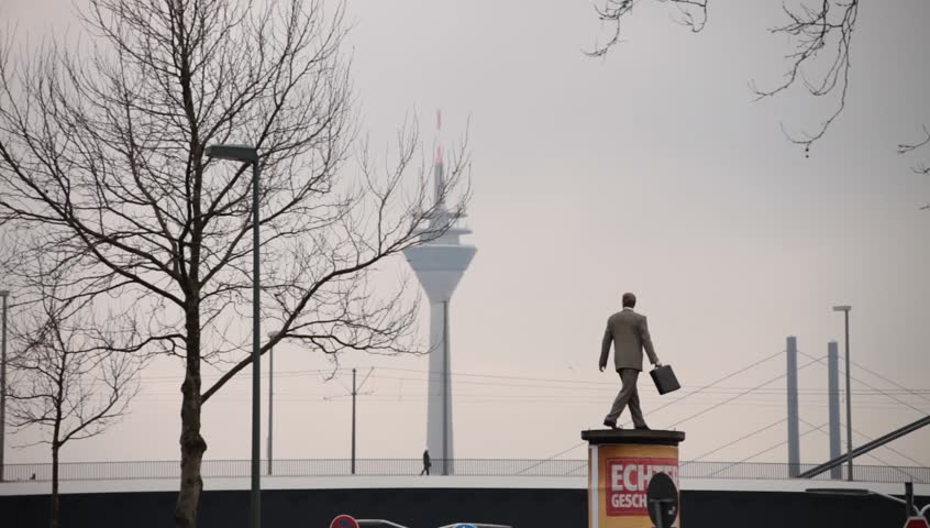 DUSSELDORF, GERMANY â FEBRUARY 28: The Businessman statue by Christoph PÃ¶ggeler is a symbol of the city present status as a powerful economic center.  February 28, 2013,  DÃ¼sseldorf, Germany
