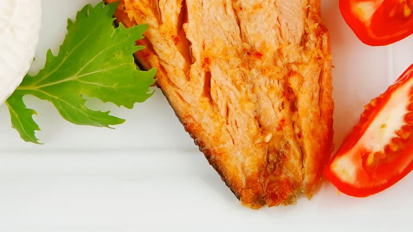 grilled salmon and tomatoes on white plate
