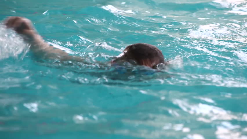 Little girl swimming in the pool.