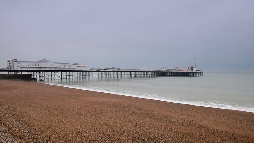 The Brighton Pier in Brighton, UK. Wideangle shot of the beach and ocean.