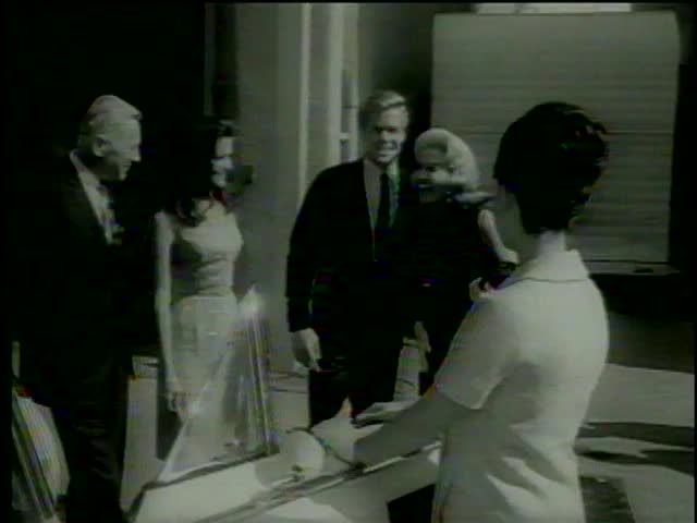 Chrysler executive shows D. McClure, M. Maxwell, P. Tiffin and J. Sommers the turbine engined car in Universal City, CA circa 1964-MGM PICTURES, UNIVERSAL-INTERNATIONAL NEWSREEL, USA, filmed in 1964