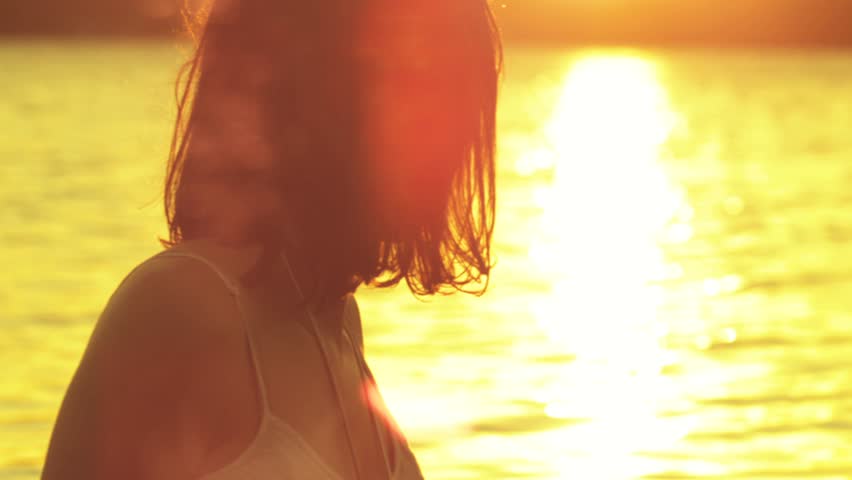Young woman watching the sunset, Shot on RED EPIC