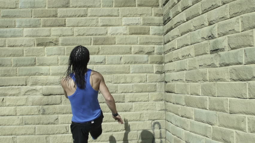 Backflip - A free runner back flips off a wall in super slow motion