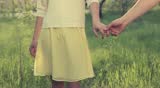 Cuddle of hands in blossom garden. Closeup