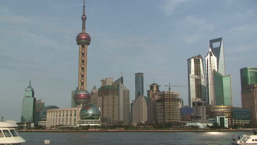 Passenger boat passing Shanghai's famous skyscrapers of Lujiazui district in Pudong.