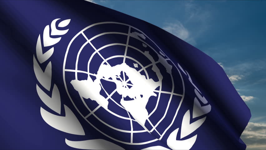 United Nations Flag waving in wind with clouds in background