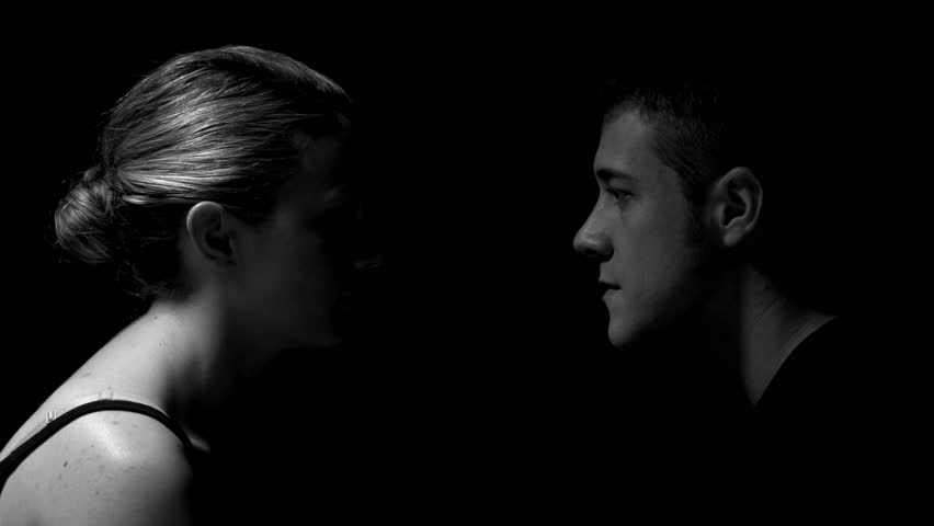 Studio shoot of man and woman facing each other in black and white. Experimental lighting. 