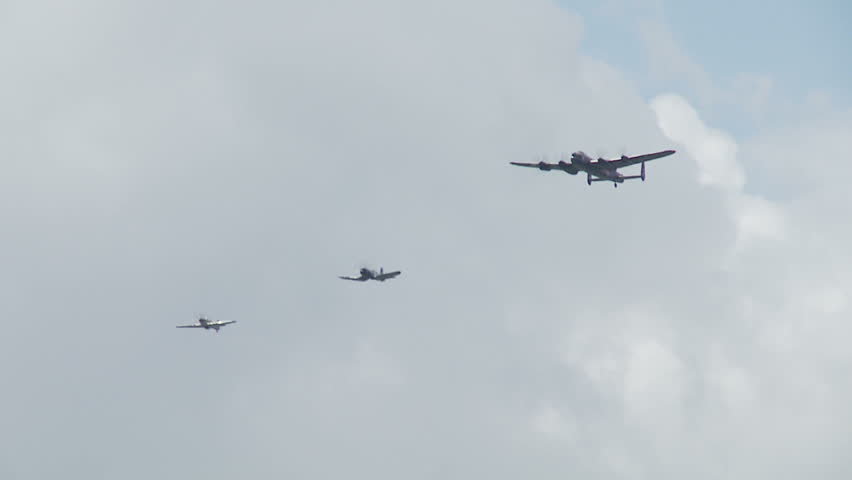 Avro Lancaster bomber flying in formation with an RAF Spitfire and a US Navy Corsair fighter-bomber from World War II. Recorded in slow motion at 60fps.