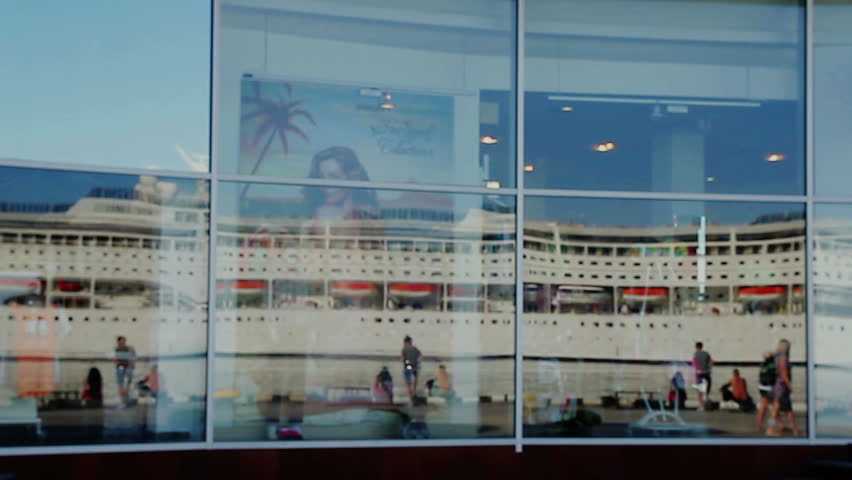 cruise ship with tourists in the reflection of windows