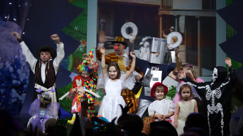MOSCOW - JAN 04: Kids waving on stage with screen behind them at Forum hall Moscow masquerade of Moscow families, on Jan 04, 2012 in Moscow, Russia.