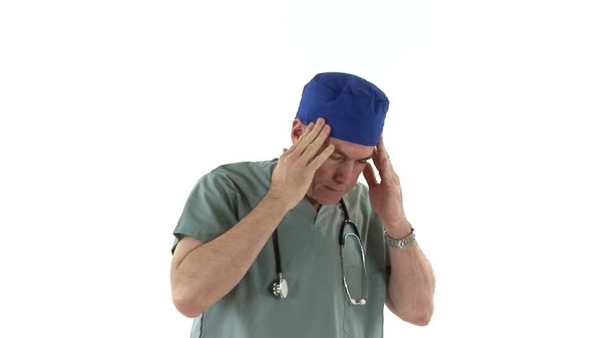 A man dressed in scrubs who appears to be a weary surgeon.