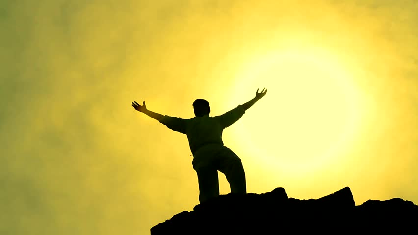 Success Pose by Man on Top of Hill Lifting Hands toward Sun Color Background silhouette 