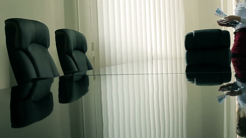Woman secretary lays out the documents on the table for presentation