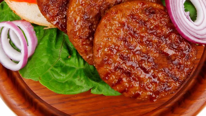 several large roast hamburger with loaf on wooden plate 1920x1080 intro motion slow hidef hd