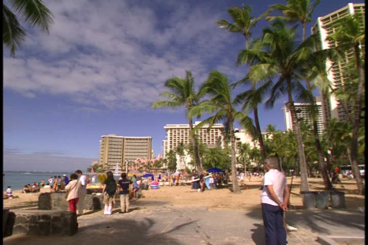 WAIKIKI BEACH, HONOLULU, HAWAII - JANUARY 30, 1997: scenic b-roll of Waikiki Beach, Hawaii: fast spinning counter clockwise panorama of beach, palm trees, hotel and people.