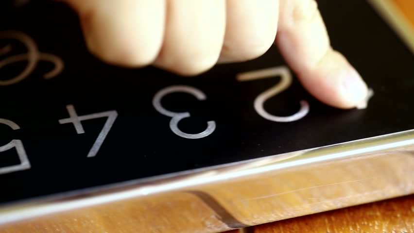 Dolly shot of child's hand pointing numbers from one to ten on a tablet.