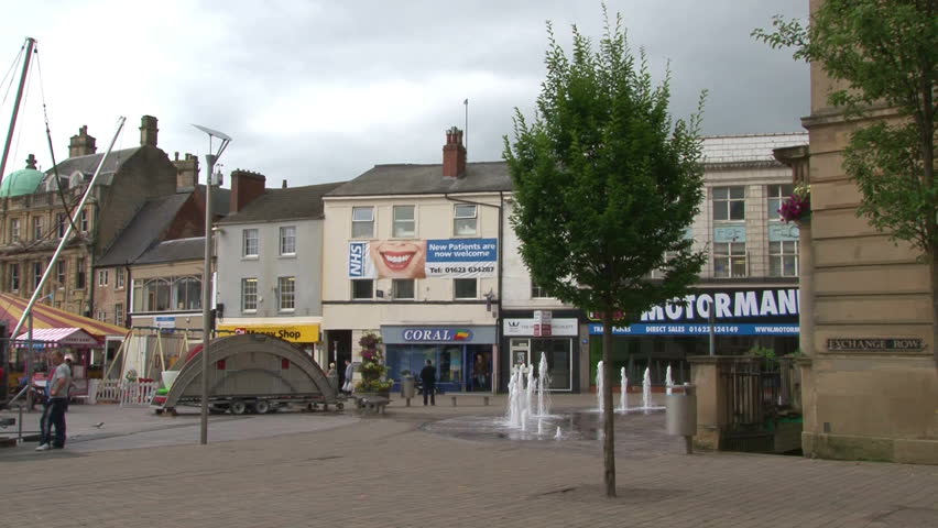 MANSFIELD, UK - AUGUST 2012:Mansfield's central marketplace with a temporary funfair alongside the stalls.